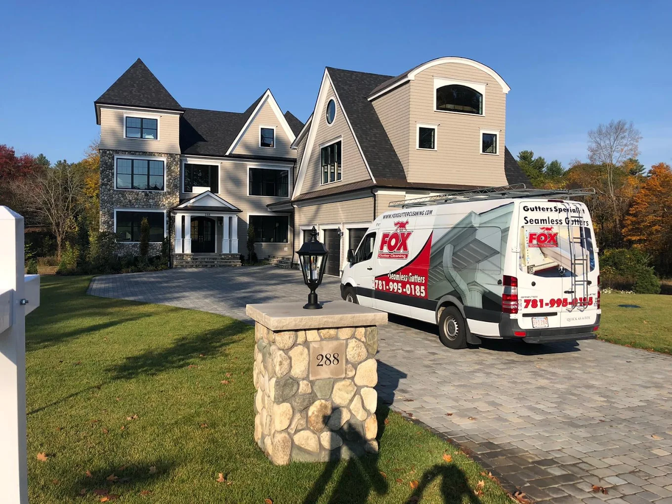 Professional worker cleaning residential gutters